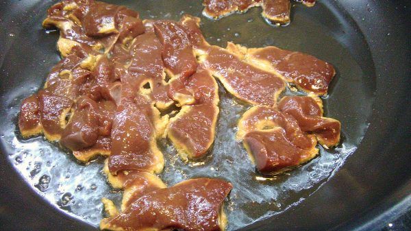 Thin sliced beef liver in pan